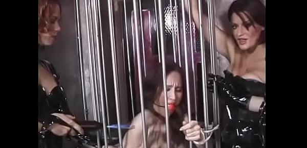  Three sluts in latex lingerie take a lustful chick out of the cage on a leash and pour hot wax on her chest